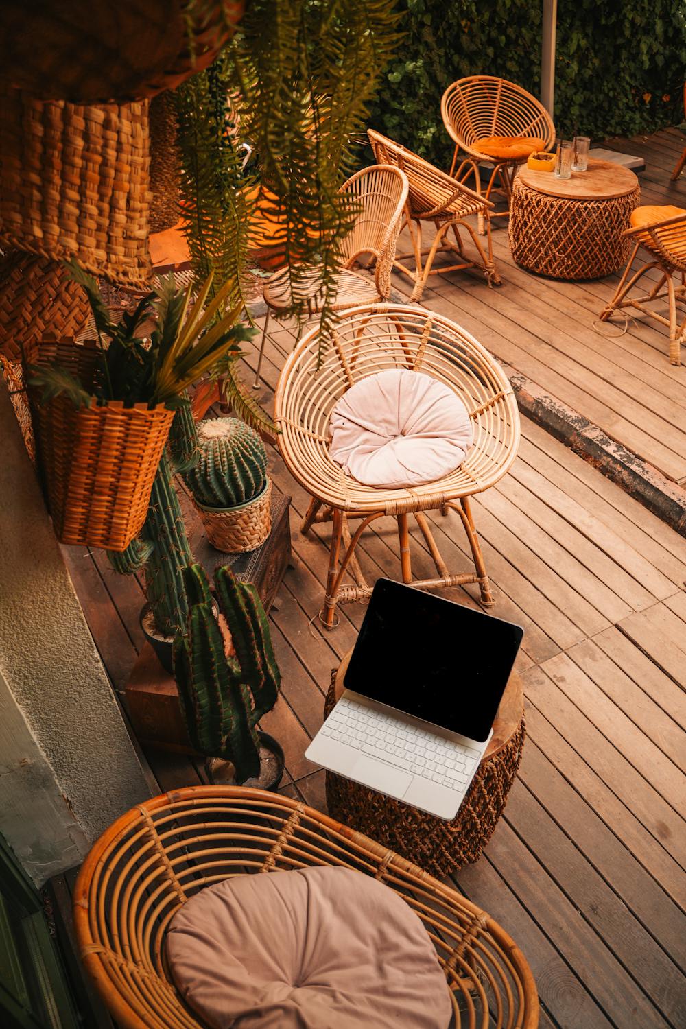 free-photo-of-cozy-outdoor-patio-with-bamboo-chairs-and-laptop